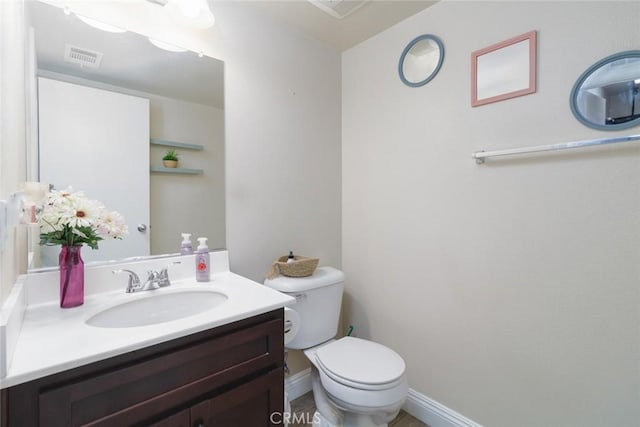 bathroom with toilet and vanity