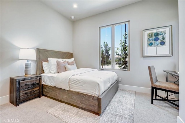 bedroom with light carpet and baseboards