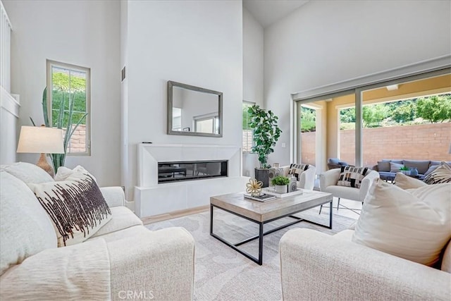 living room featuring high vaulted ceiling and a wealth of natural light