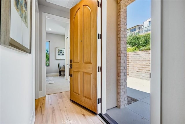 entryway featuring light wood-type flooring and baseboards