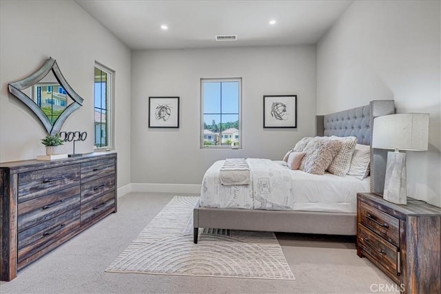 bedroom with baseboards, recessed lighting, visible vents, and light colored carpet