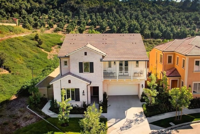 view of front of house featuring a balcony and a garage