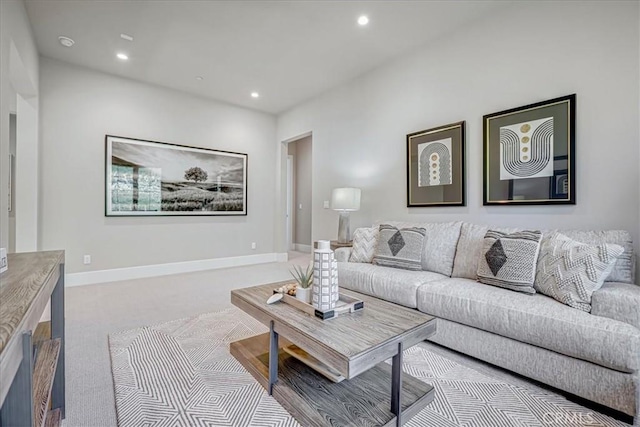 living area featuring baseboards, light colored carpet, and recessed lighting