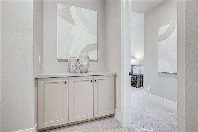 interior space featuring carpet flooring and baseboards