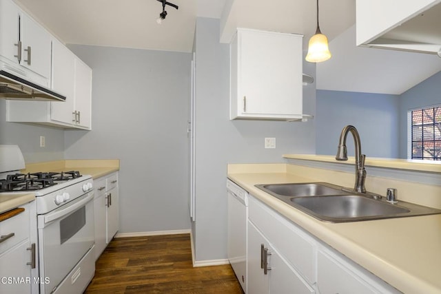 kitchen with lofted ceiling, pendant lighting, sink, white appliances, and white cabinets