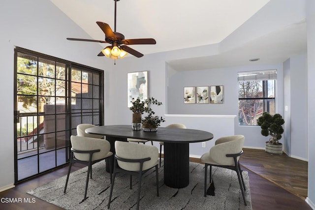 dining room with ceiling fan, dark hardwood / wood-style flooring, and lofted ceiling