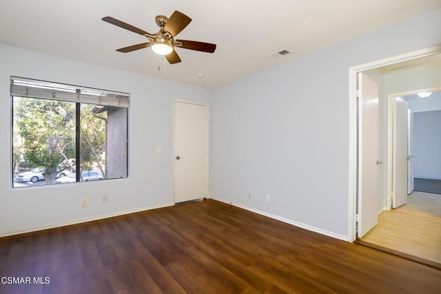 empty room with ceiling fan and hardwood / wood-style floors