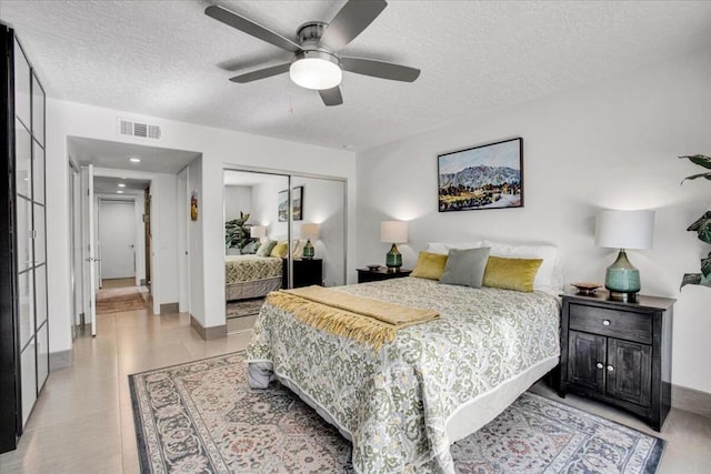 bedroom with a textured ceiling, a closet, and ceiling fan