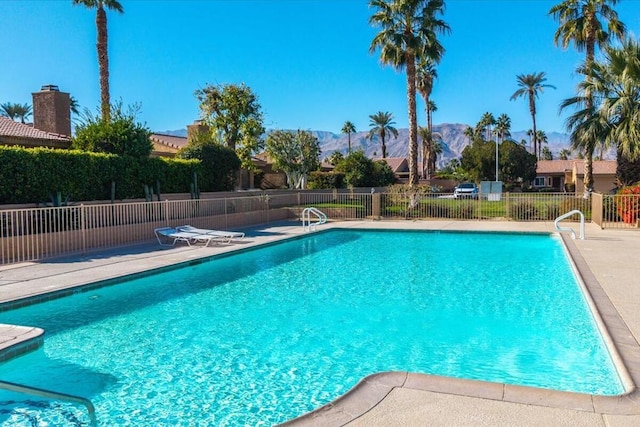 view of pool featuring a mountain view and a patio area