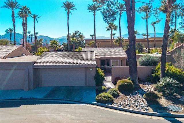 ranch-style home featuring a garage and a mountain view