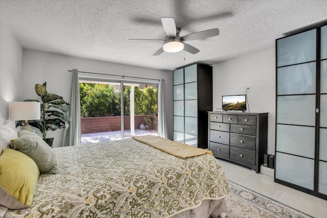 bedroom featuring a textured ceiling, access to outside, and ceiling fan