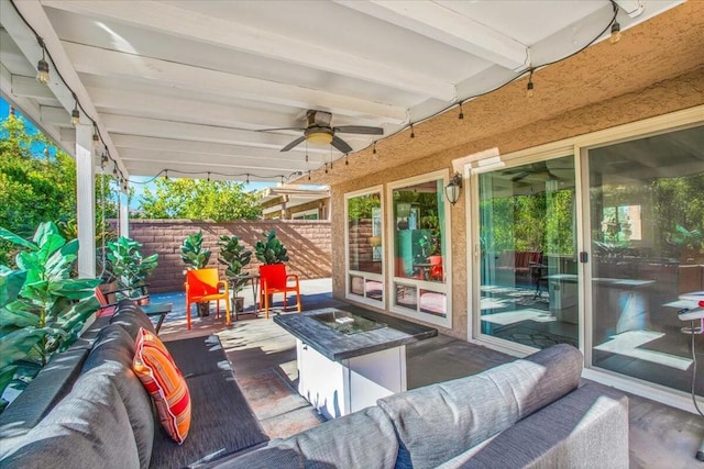 view of patio with an outdoor living space with a fire pit and ceiling fan