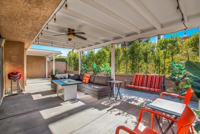 view of patio / terrace featuring area for grilling, an outdoor living space with a fire pit, and ceiling fan