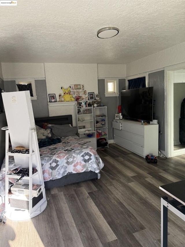 bedroom featuring a textured ceiling and hardwood / wood-style floors