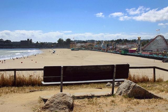 view of yard with a view of the beach and a water view