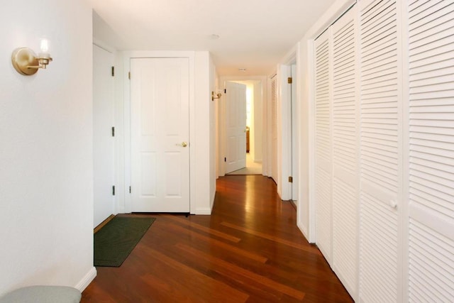 hallway with dark hardwood / wood-style flooring