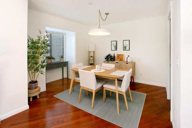 dining space with dark wood-type flooring