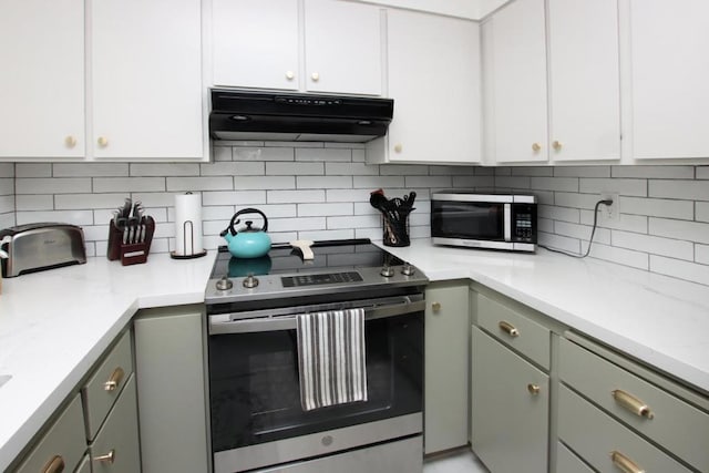 kitchen with appliances with stainless steel finishes, backsplash, white cabinetry, and gray cabinets