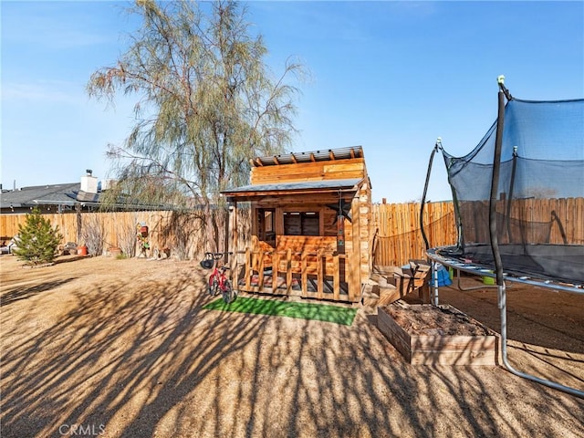 view of yard with an outdoor bar and a trampoline