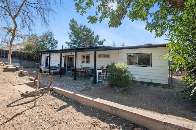 view of front of property with an outdoor living space and a patio area