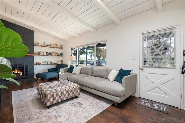 living room featuring wood ceiling, dark hardwood / wood-style floors, lofted ceiling with beams, and a brick fireplace