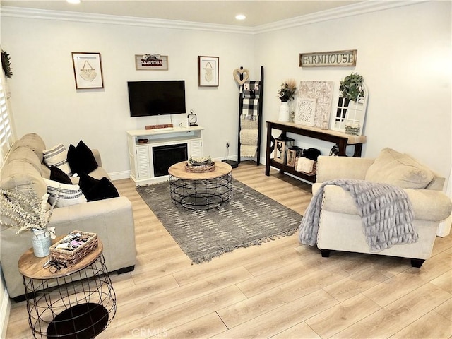 living room featuring light wood-type flooring and ornamental molding