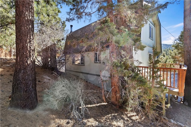 view of side of home with a deck