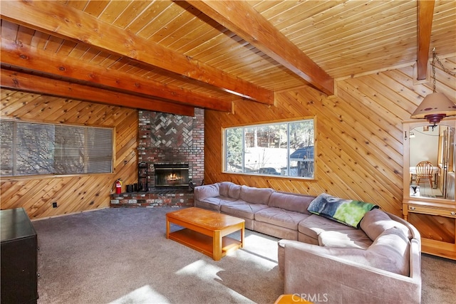 carpeted living room featuring beam ceiling, a fireplace, wooden ceiling, and wood walls