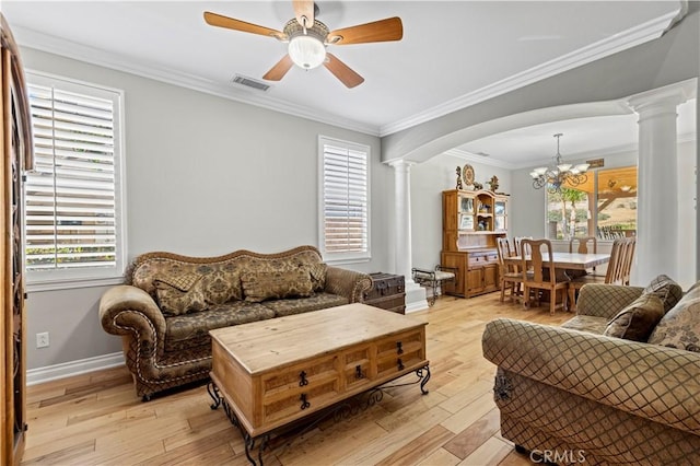 living room featuring crown molding, light hardwood / wood-style floors, and ornate columns