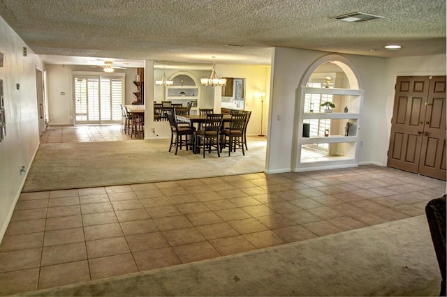 carpeted dining space with ceiling fan with notable chandelier