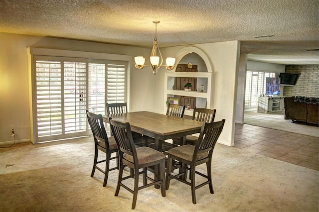 carpeted dining space with an inviting chandelier and a textured ceiling