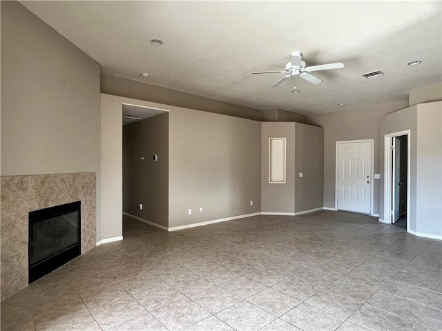 unfurnished living room featuring light tile patterned flooring, ceiling fan, and a tiled fireplace