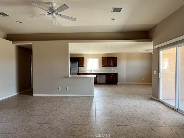 unfurnished living room featuring plenty of natural light, light tile patterned floors, and ceiling fan