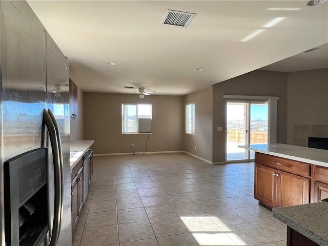 kitchen featuring ceiling fan, stainless steel appliances, and light tile patterned flooring