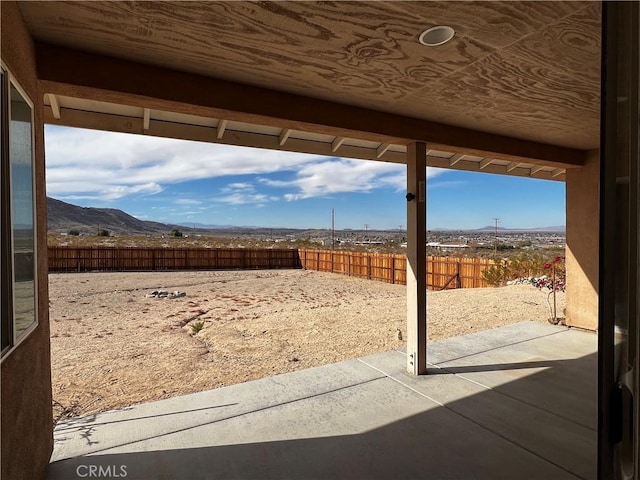 view of yard featuring a mountain view and a patio area