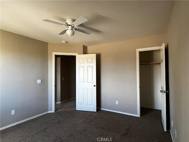 unfurnished bedroom featuring dark colored carpet, a closet, and ceiling fan