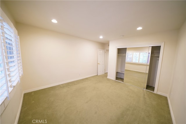 unfurnished bedroom with a closet and carpet flooring