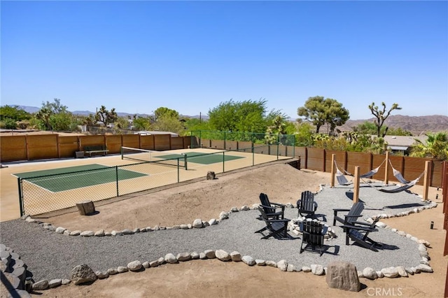 view of community with tennis court and a mountain view