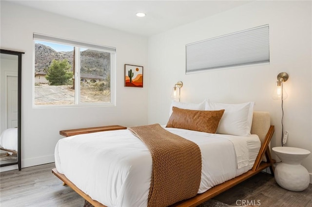 bedroom with hardwood / wood-style flooring