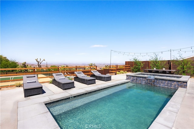 view of swimming pool with an in ground hot tub and a patio