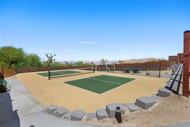 view of tennis court with a mountain view