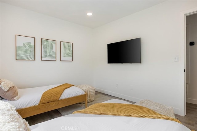 bedroom with hardwood / wood-style flooring