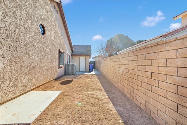 view of side of home featuring a patio and central AC unit