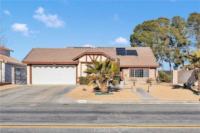 view of front of home with a garage and solar panels