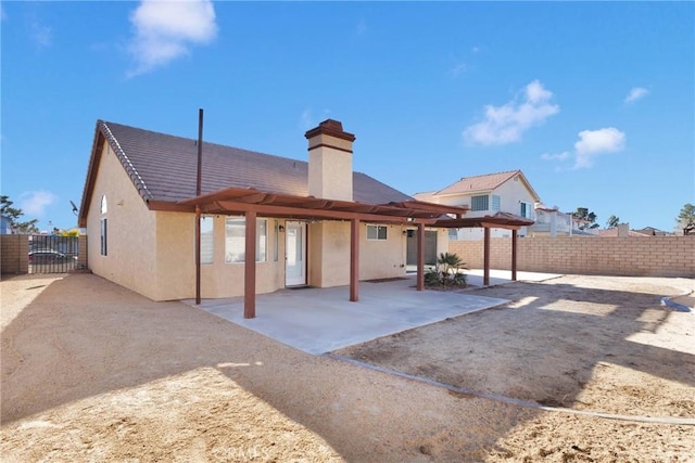 rear view of property featuring a patio area and a pergola