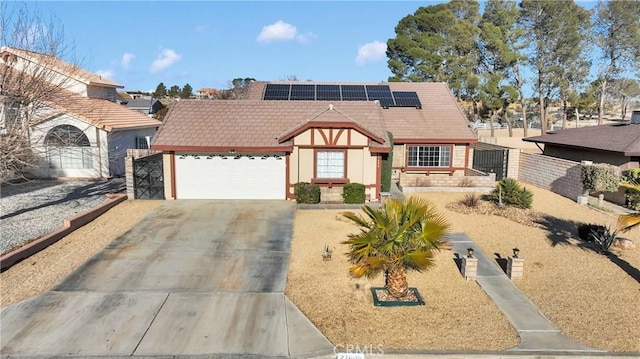 view of front of property featuring a garage and solar panels