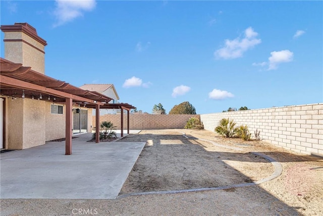 view of yard featuring a patio and a pergola