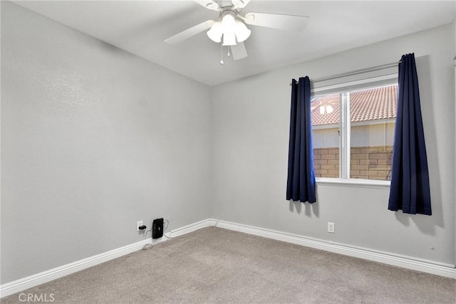 spare room featuring ceiling fan and carpet