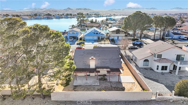 birds eye view of property with a water and mountain view