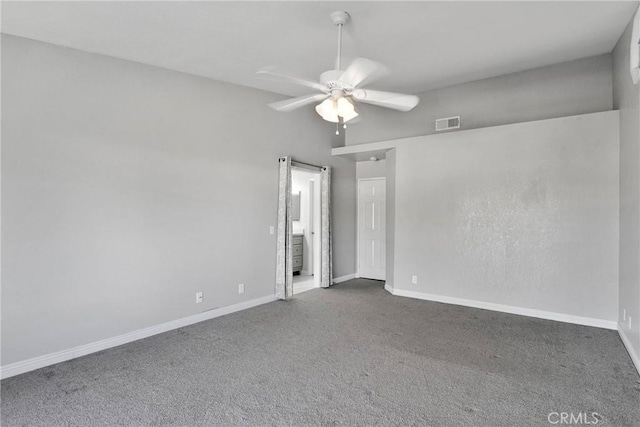 unfurnished room featuring ceiling fan and dark colored carpet